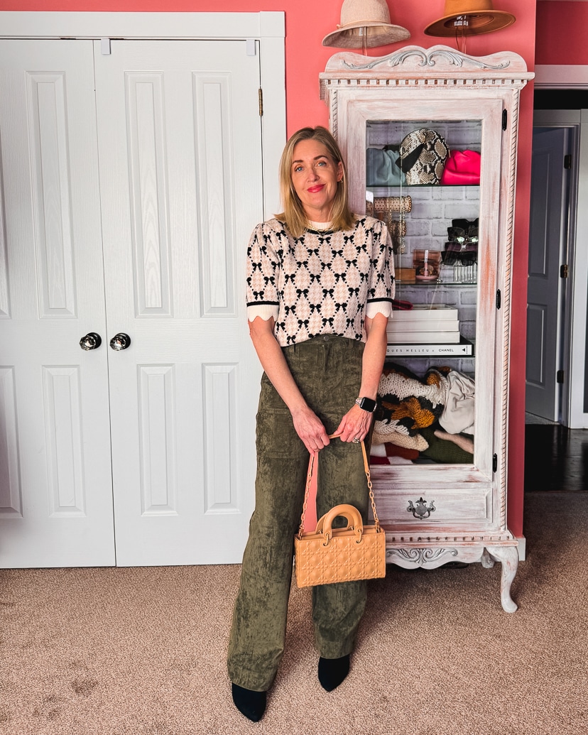 fashion blogger wearing a short sleeve bow sweater with olive green suede pants.