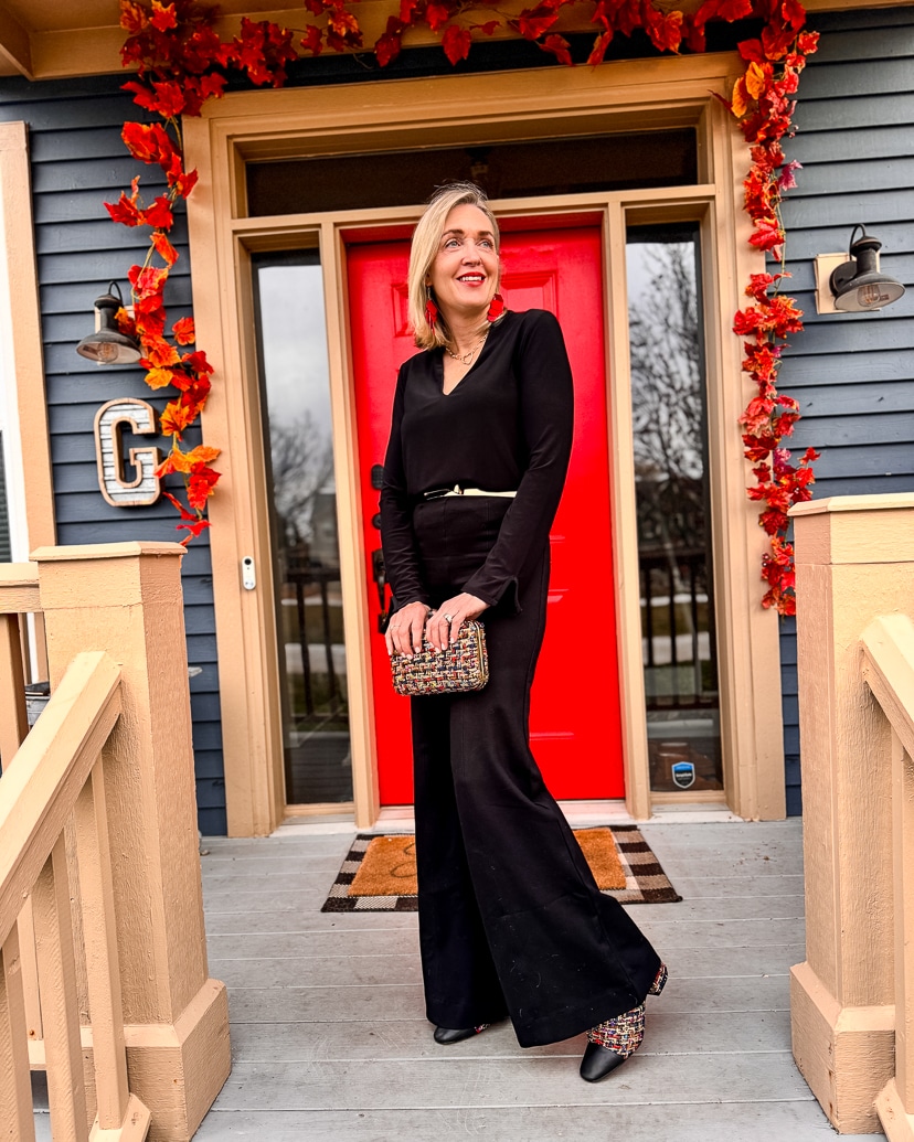 black monochrome holiday outfit with tweed booties and handbag