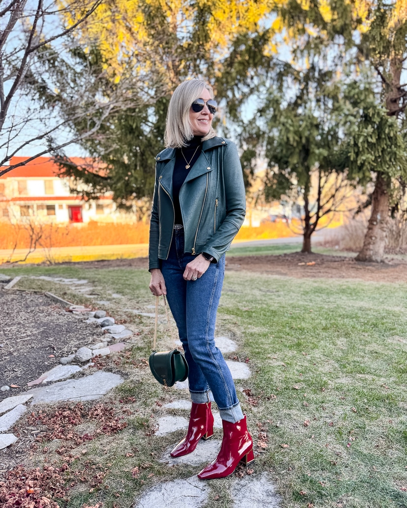 casual holiday party outfit - green leather jacket, denim and red booties