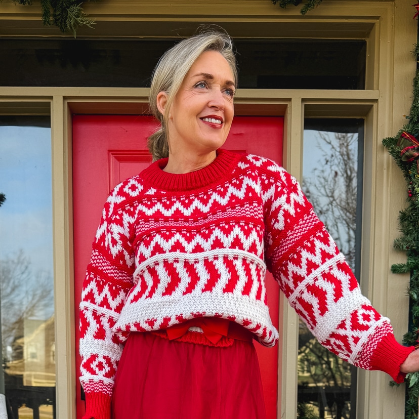 woman wearing a warm and festive christmas outfit with a red and white fair isle sweater